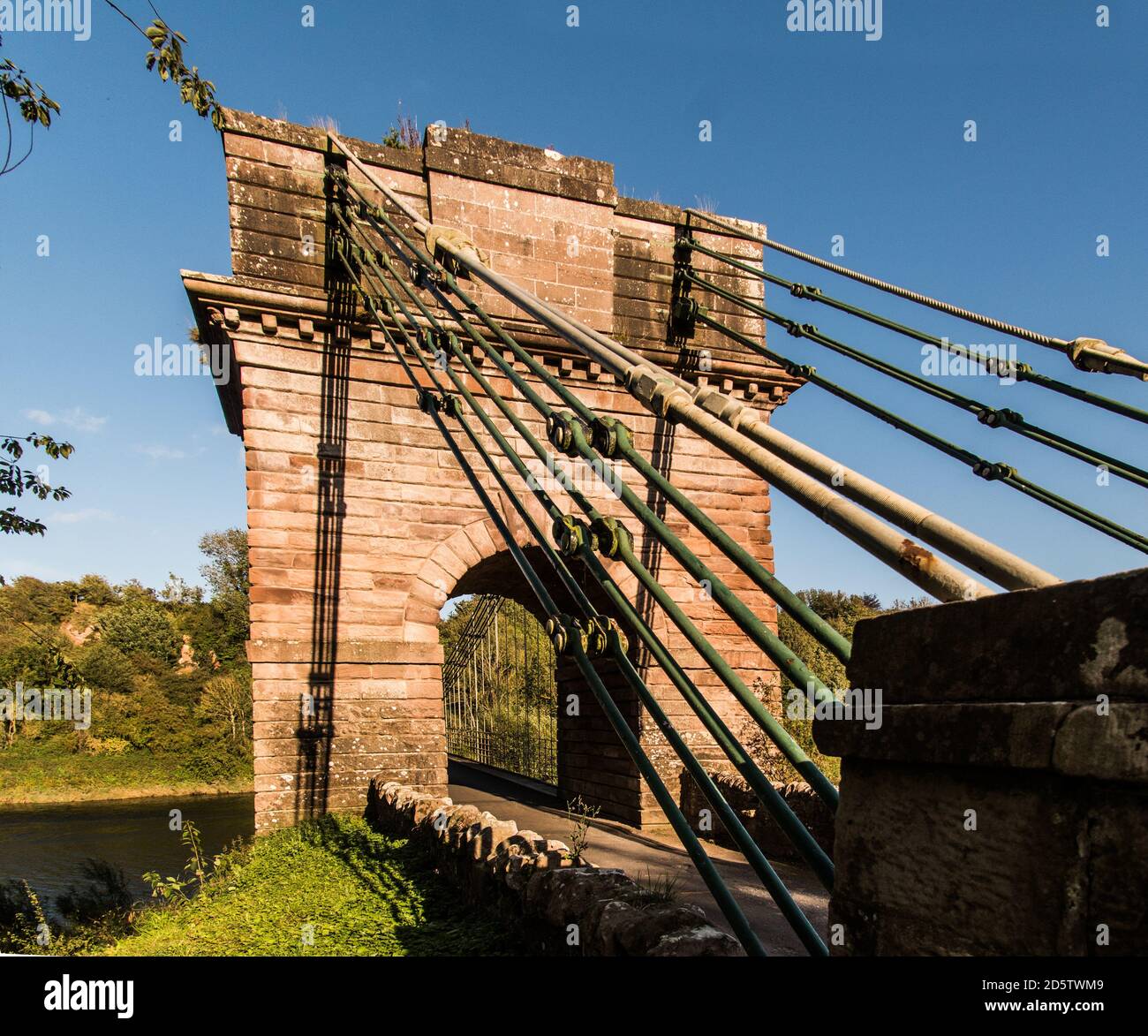 Union Bridge, a 200 year old chain bridge, spans the River Tweed, bridges the borders of England and Scotland. Stock Photo