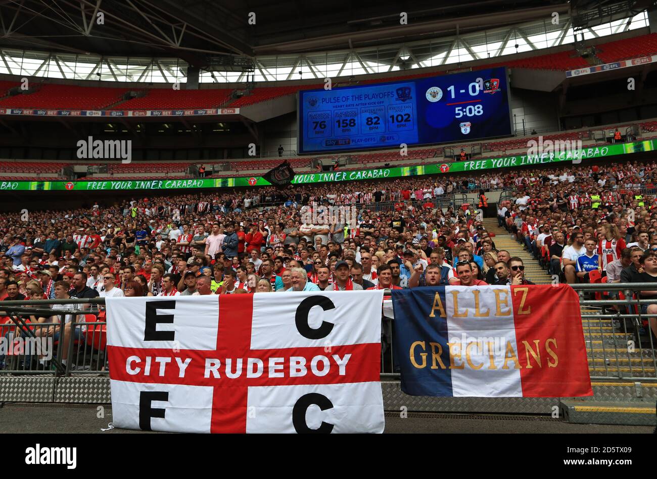 Exeter City fans in the stands infront of the scoreboard  Stock Photo