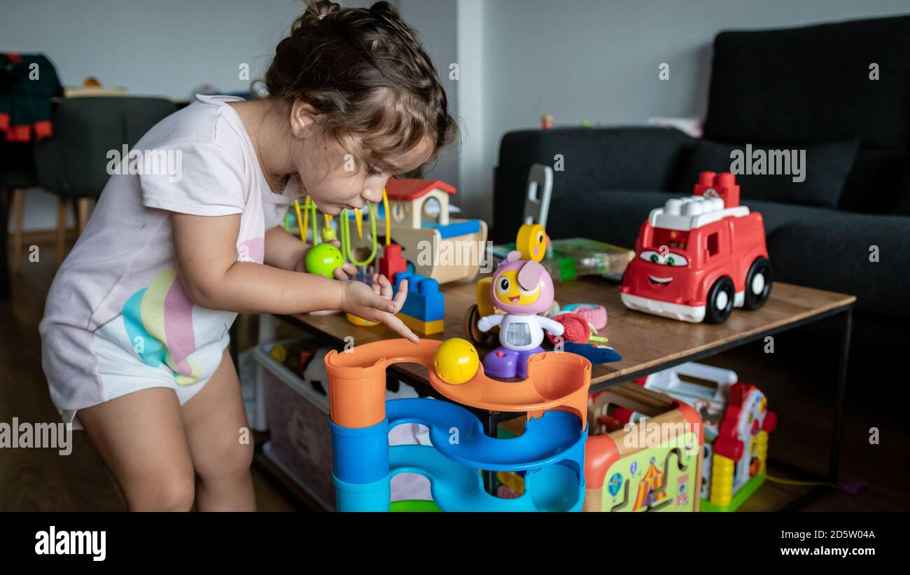 cute two years old girl playing at home with her toys Stock Photo