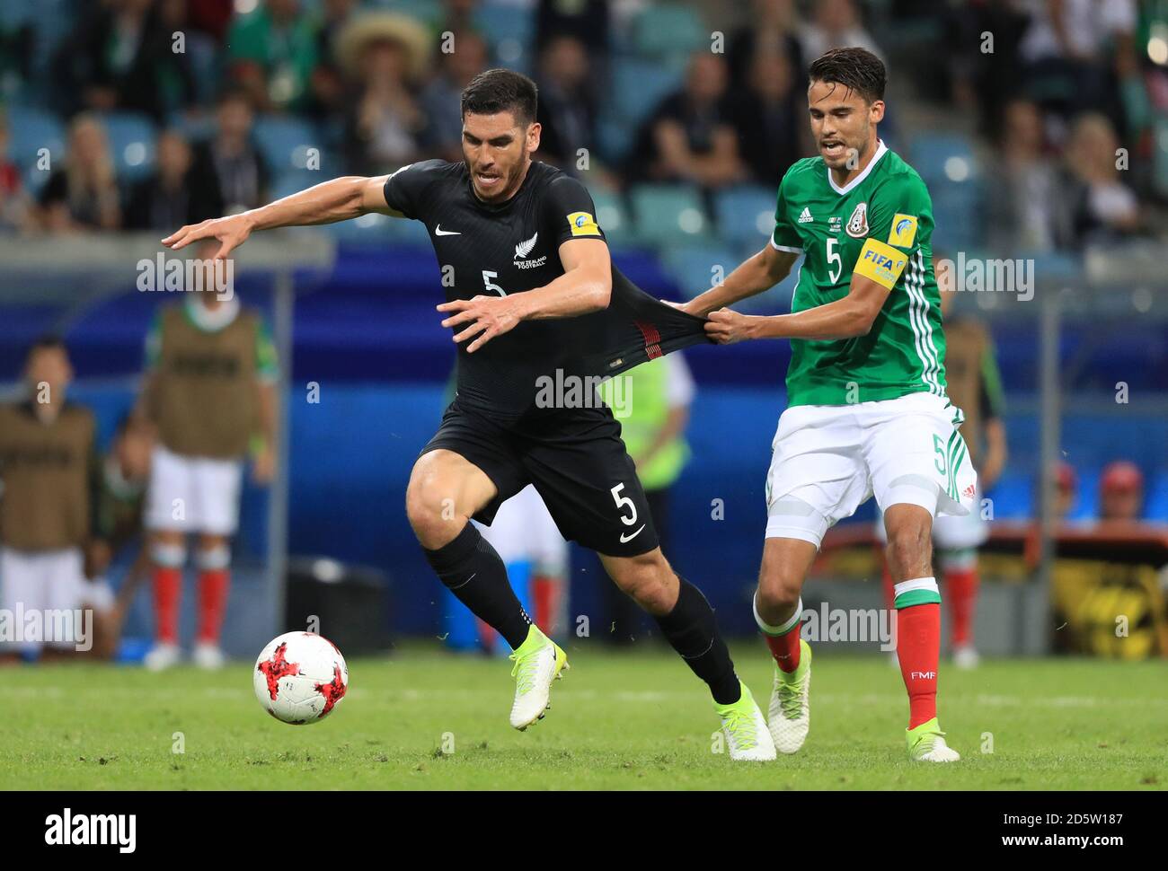 Mexico's Diego Reyes pulls back New Zealand's Michael Boxall (left), eventually resulting in a foul and a clash between the two sets of players  Stock Photo