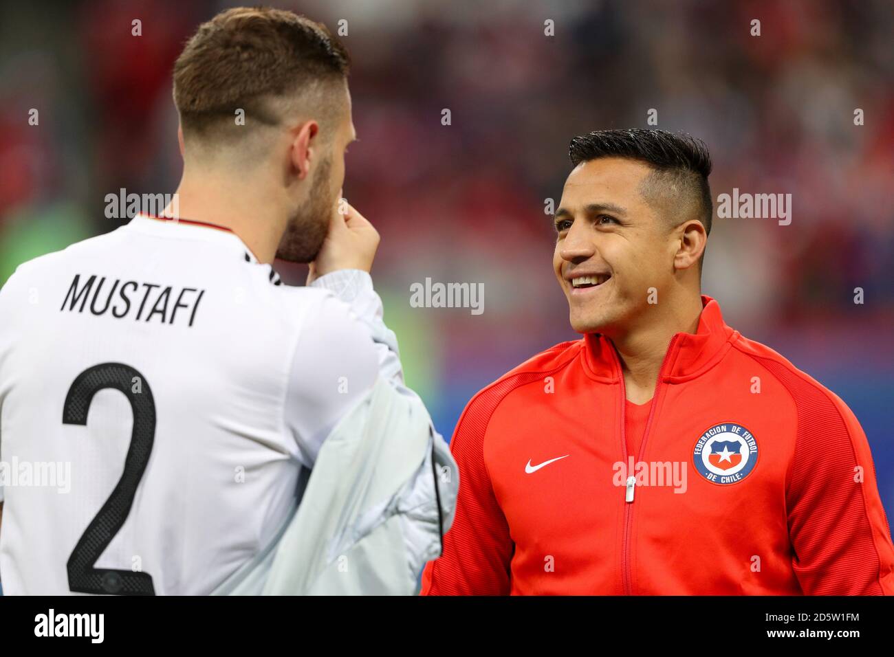 Germany's Shkodran Mustafi (left) speaks with Chile's Alexis Sanchez  Stock Photo