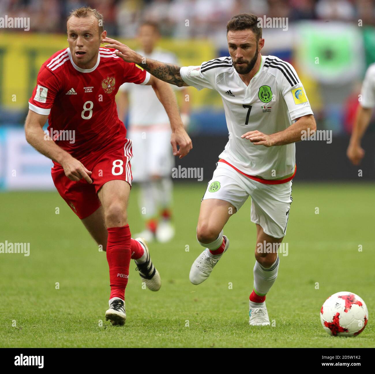 Russia's Denis Glushakov (left) and Mexico's Miguel Layun battle for the ball Stock Photo