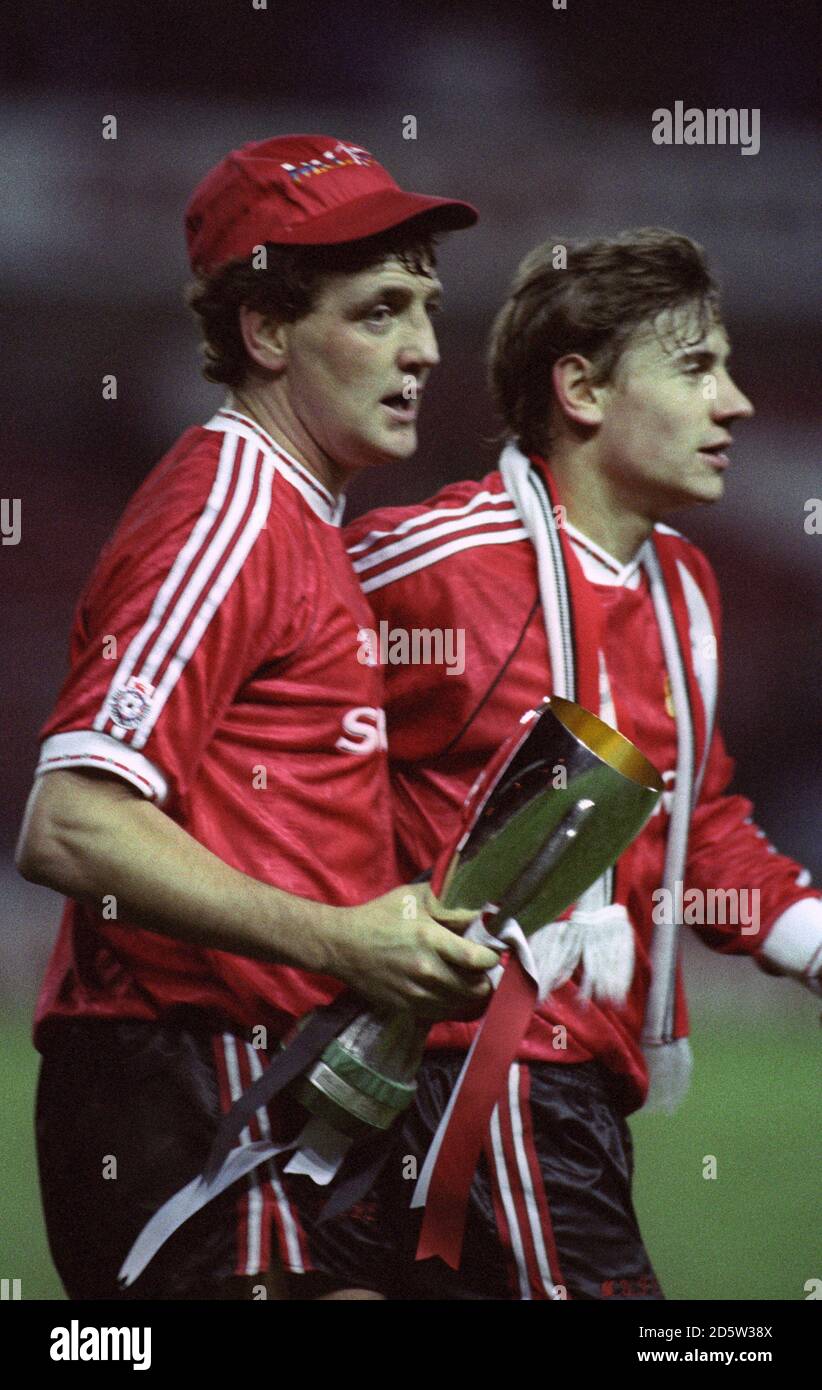 Manchester United captain Steve Bruce (l) and Andrei Kanchelskis celebrate winning the European Super Cup at Old Trafford after they defeated Red Star Belgrade 1-0 Stock Photo