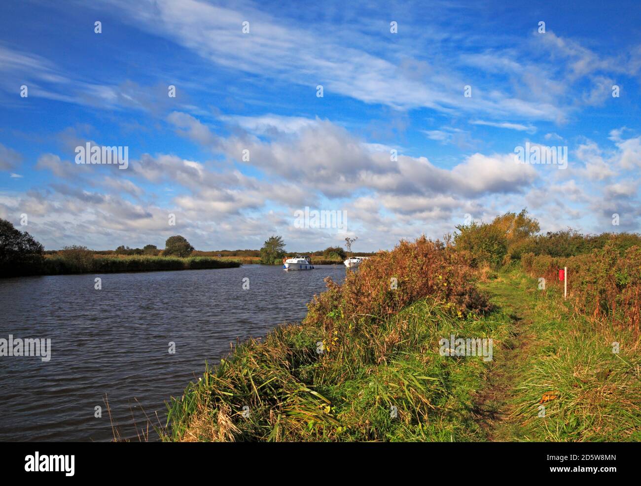 A footpath on the river bank by the River Bure near St Benet's Abbey on the Norfolk Broads at Horning, Norfolk, England, United Kingdom. Stock Photo