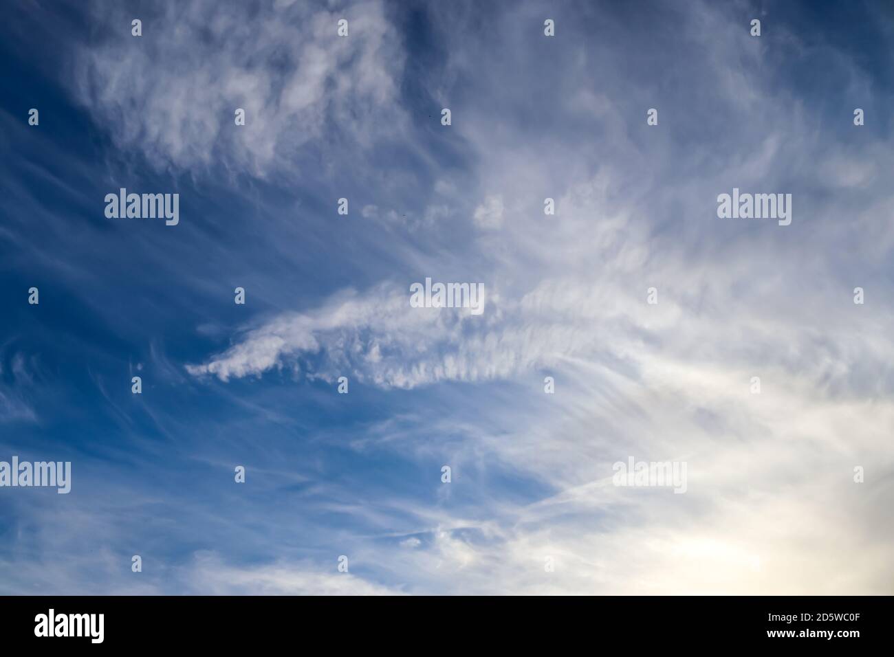 Stunning cirrus cloud formation panorama in a deep blue summer sky seen ...