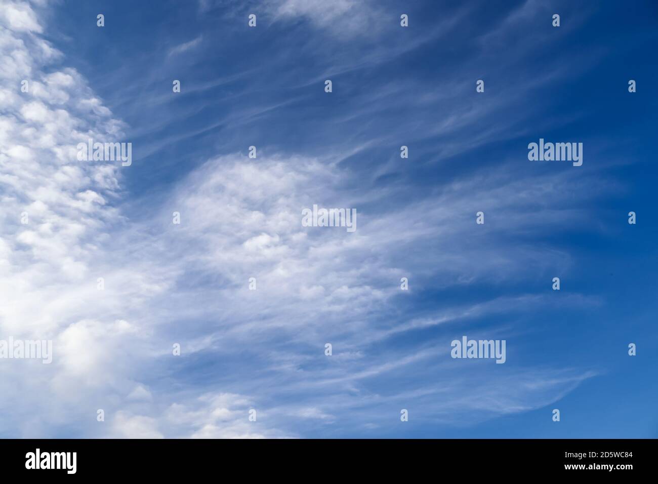 Stunning cirrus cloud formation panorama in a deep blue summer sky seen ...