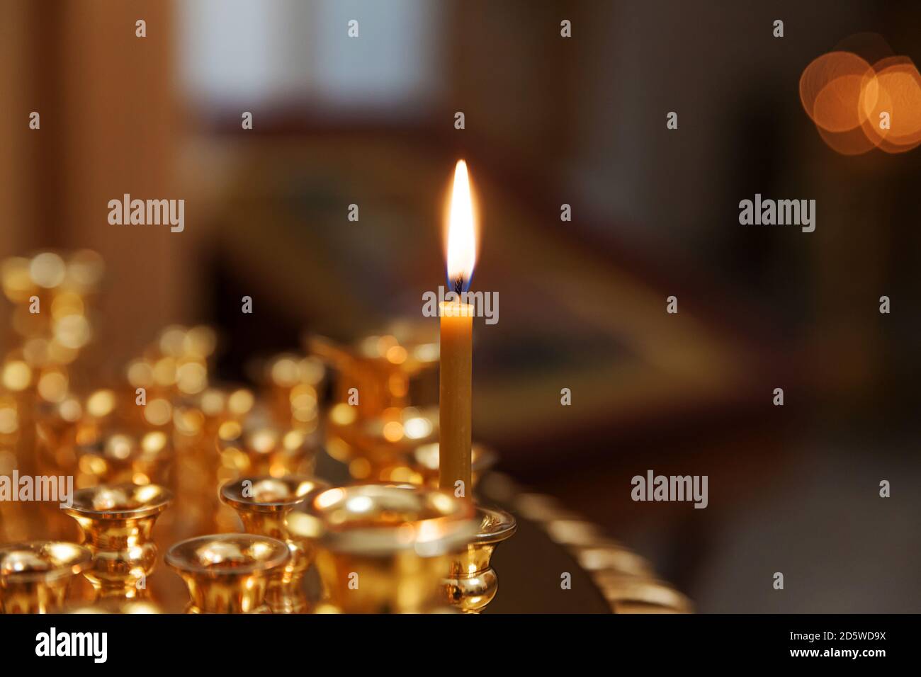 Orthodox Church. Christianity. Festive interior decoration with burning candles and icon in traditional Orthodox Church on Easter Eve or Christmas. Religion faith pray symbol Stock Photo