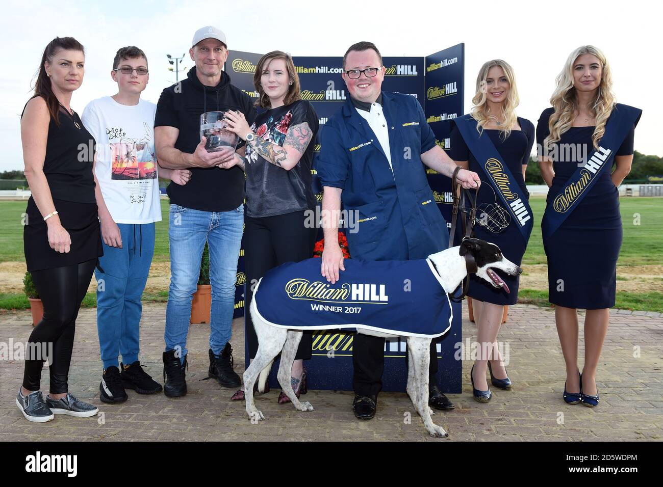 The connections of Kilara Razz are presented with a trophy after winning the William Hill Seniors at Peterborough Greyhound Stadium Stock Photo