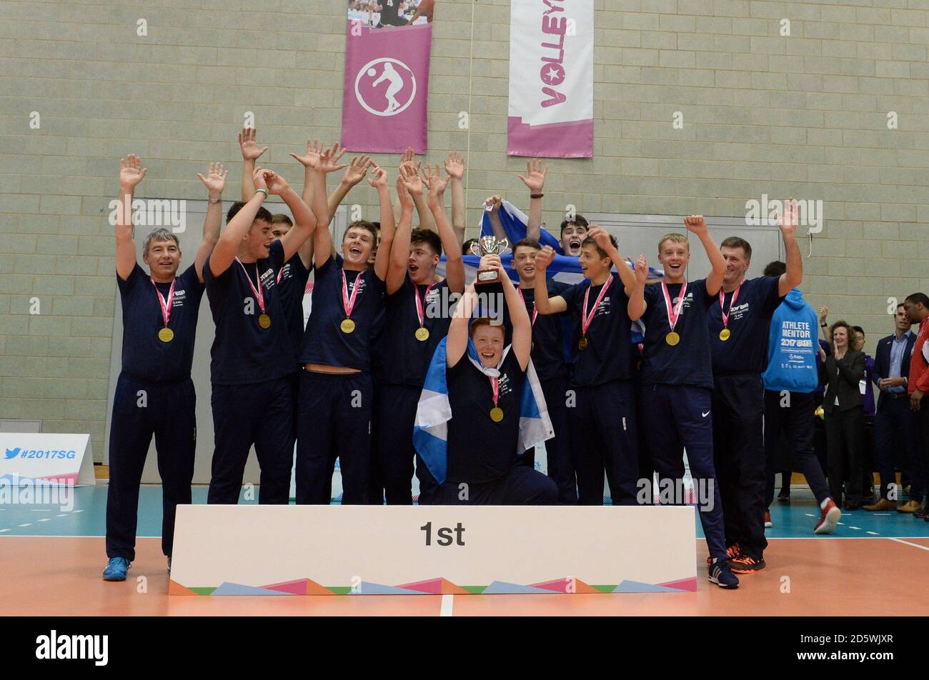 Scotland East (gold) hold up their trophy in the Volleyball