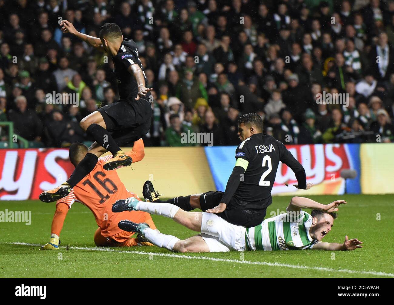 Celtic's Anthony Ralston claims for a penalty after a collision with Paris Saint-Germain's Alphonse Areola (back) Marquinhos (top) and Thiago Silva (right) Stock Photo