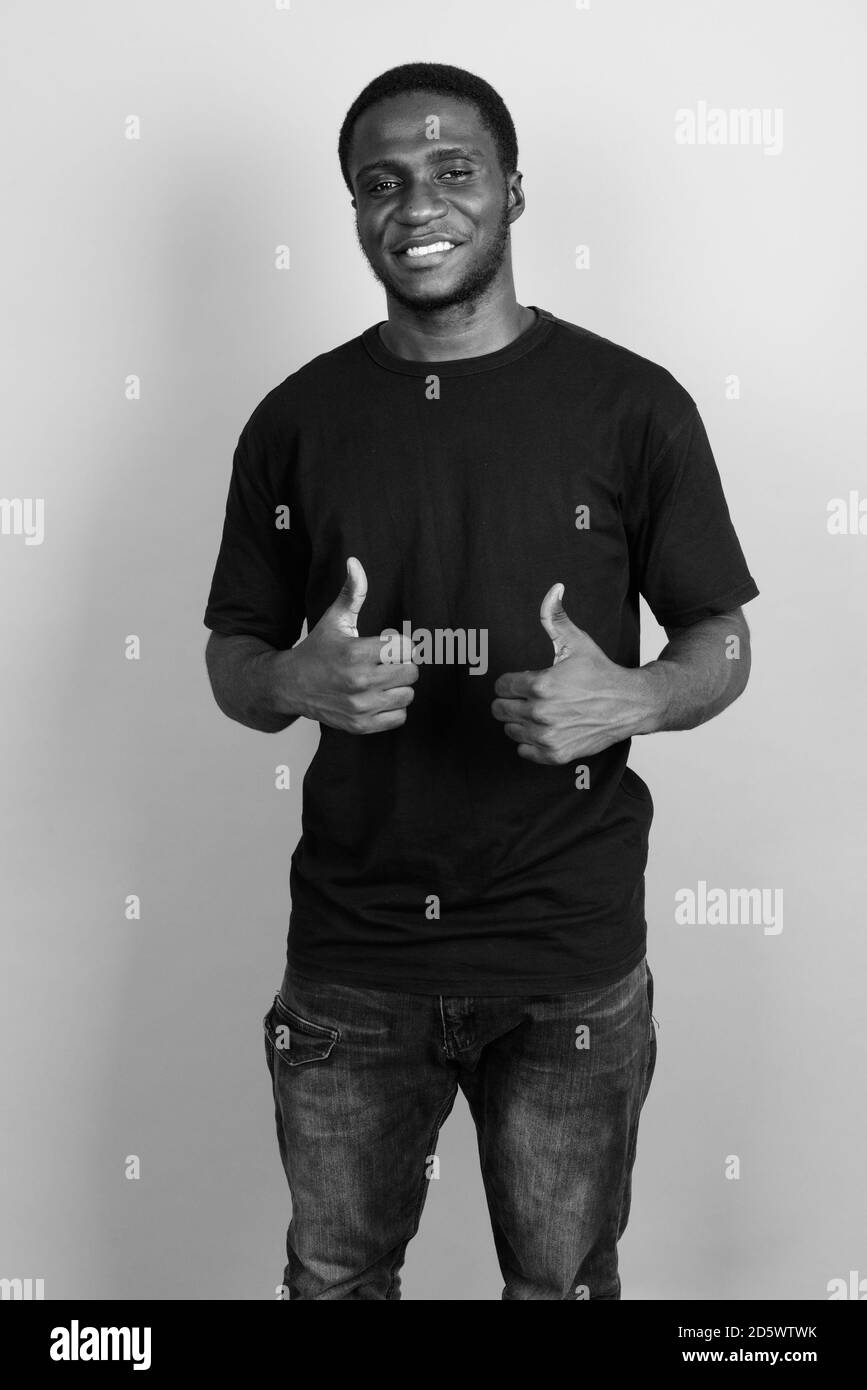 Thumbs up young african man Black and White Stock Photos & Images - Alamy