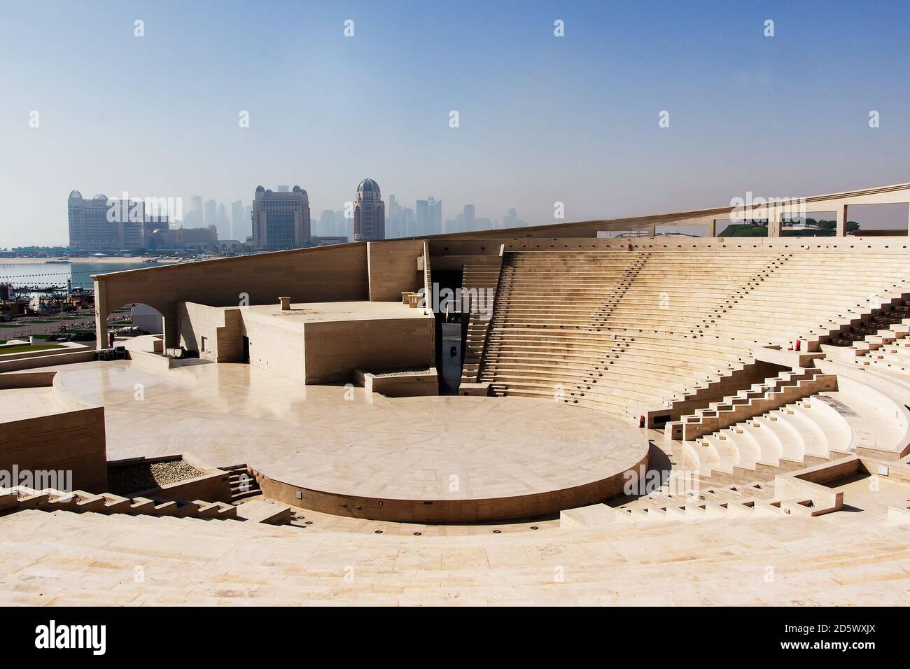 Modern amphitheatre in  Katara Cultural Village in Doha, Qatar  with skyscrapers in  background Stock Photo