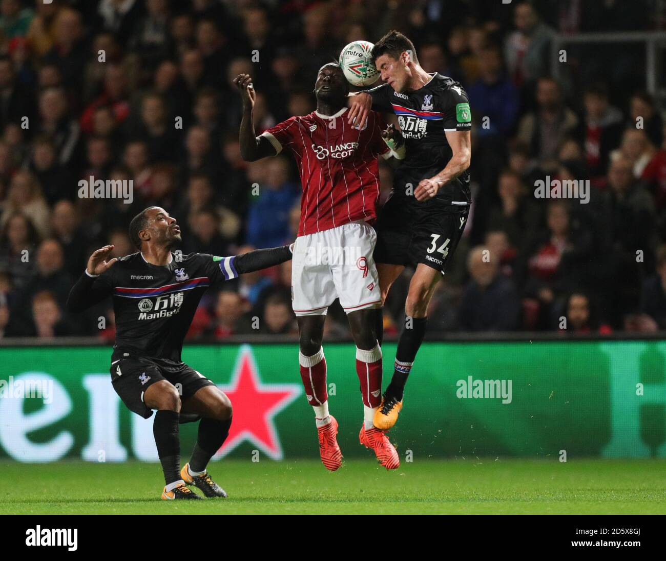 Bristol City's Famara Diedhiou and Crystal Palace's Martin Kelly (right) both jump for a header Stock Photo