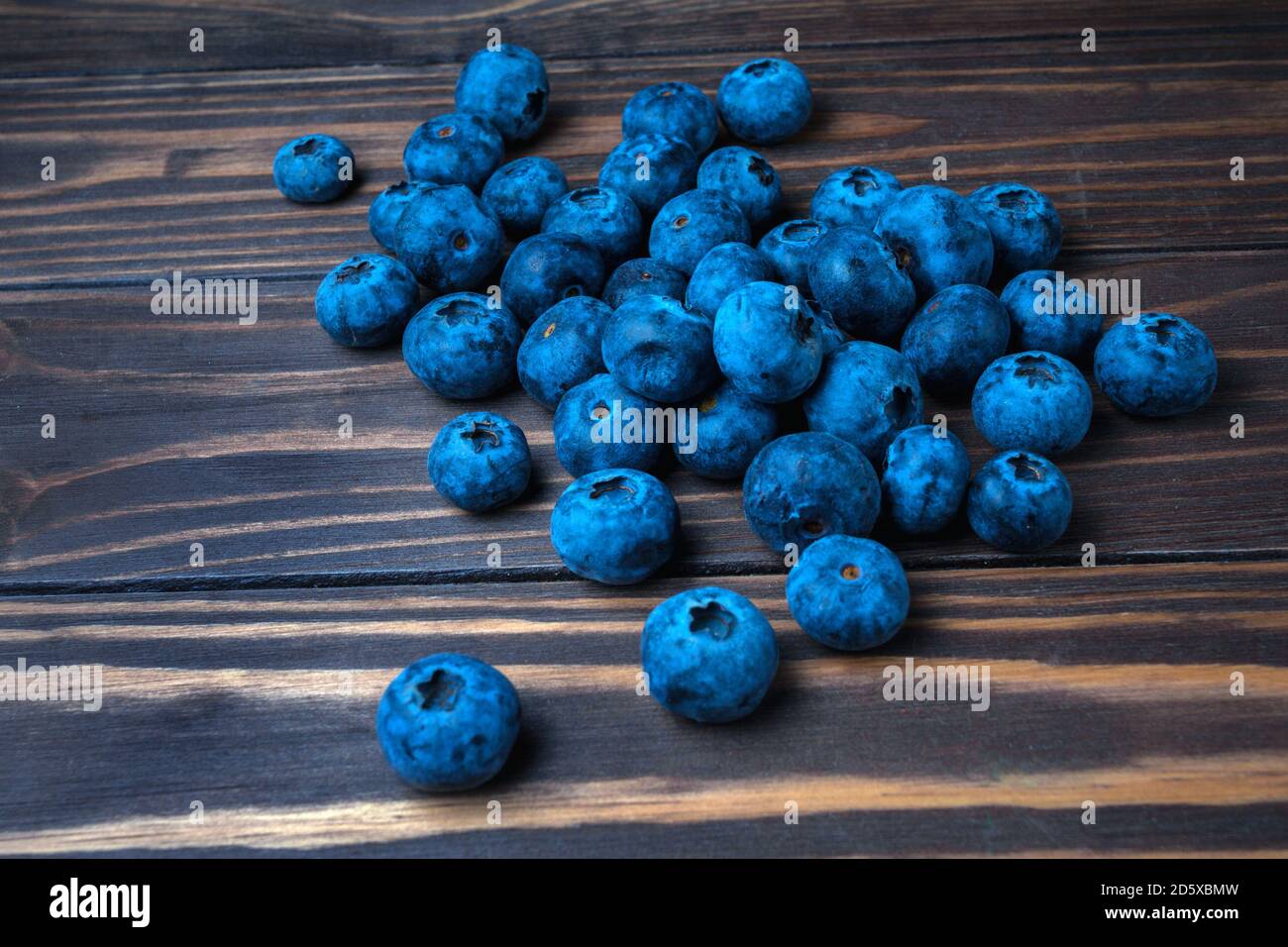 Fresh blueberries on dark boards. Background from berries. Healthy food concept. Stock Photo