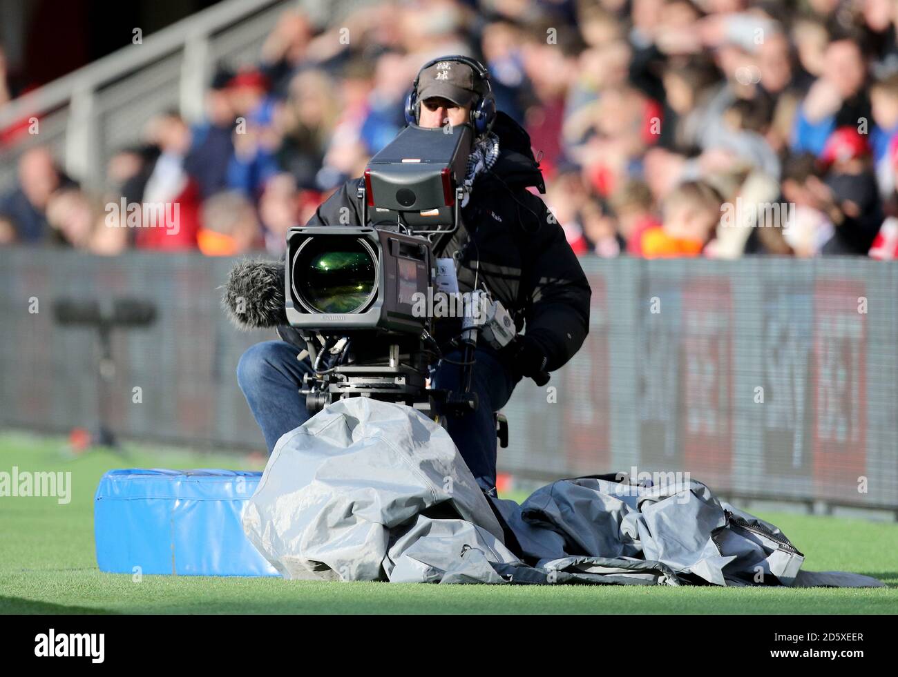 A television cameraman sits pitch side Stock Photo Alamy