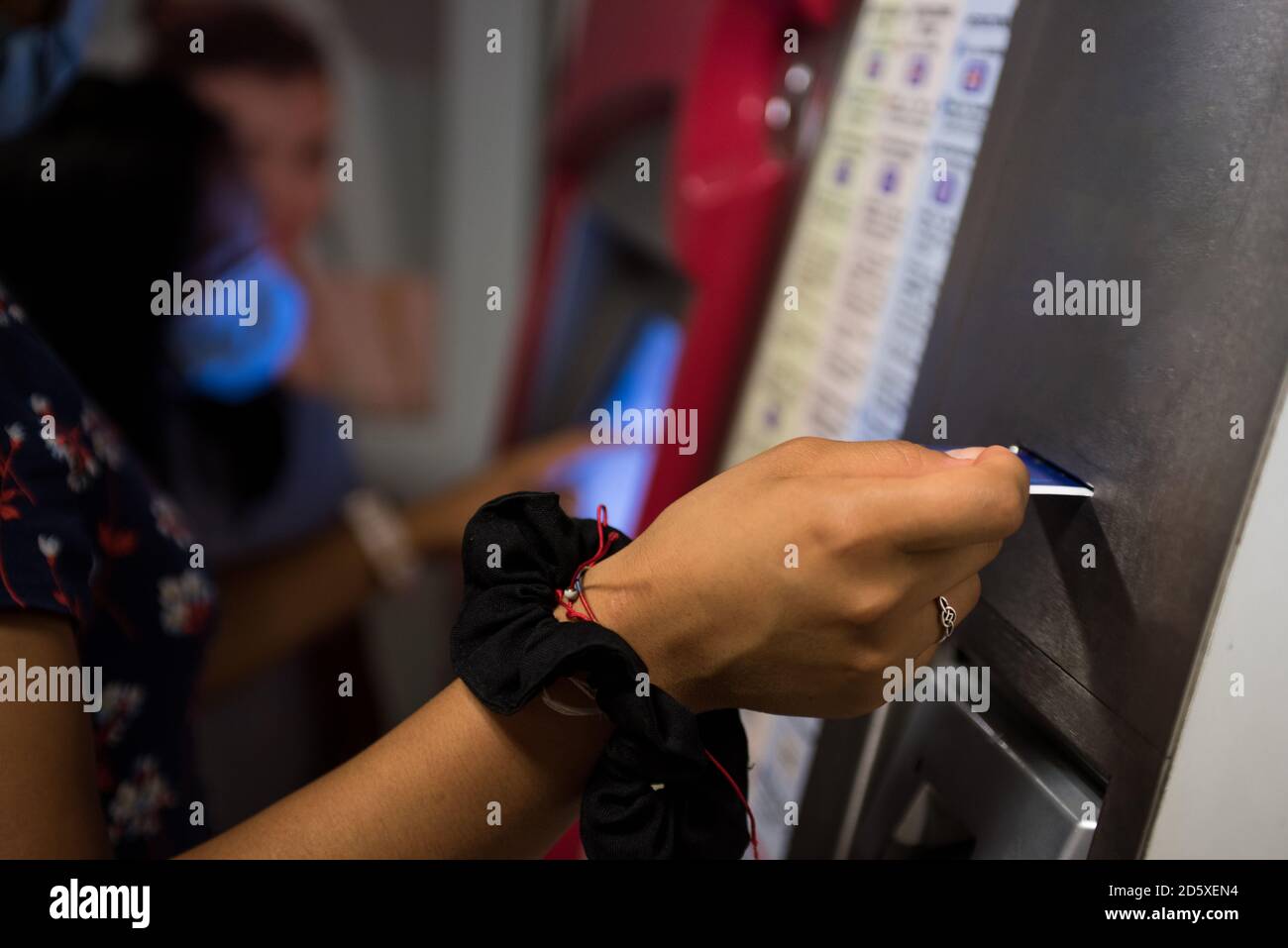 Detail photograph of a woman buying a ticket in the automatic subway ...