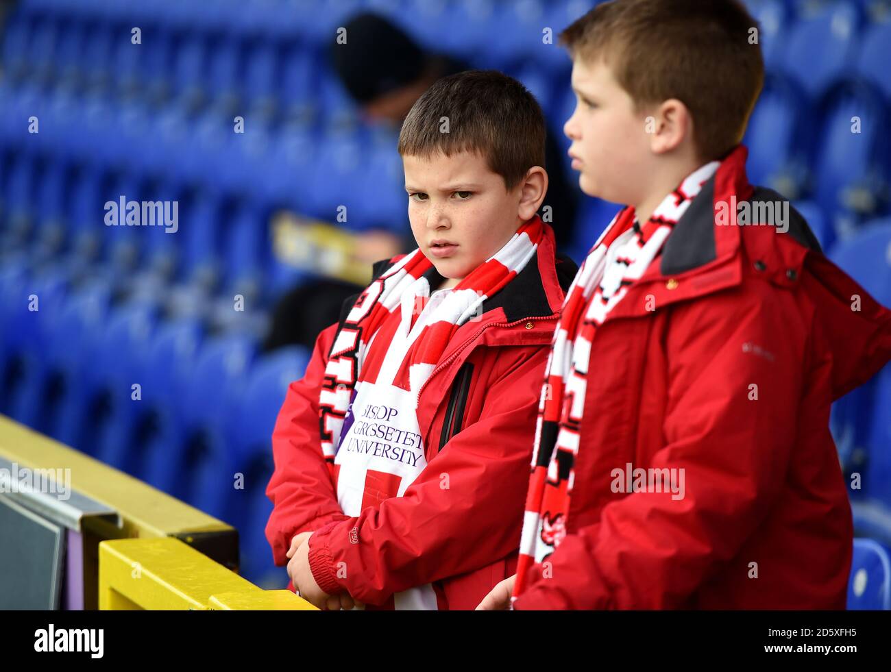 Young Lincoln City fans in the stands prior to the match Stock Photo