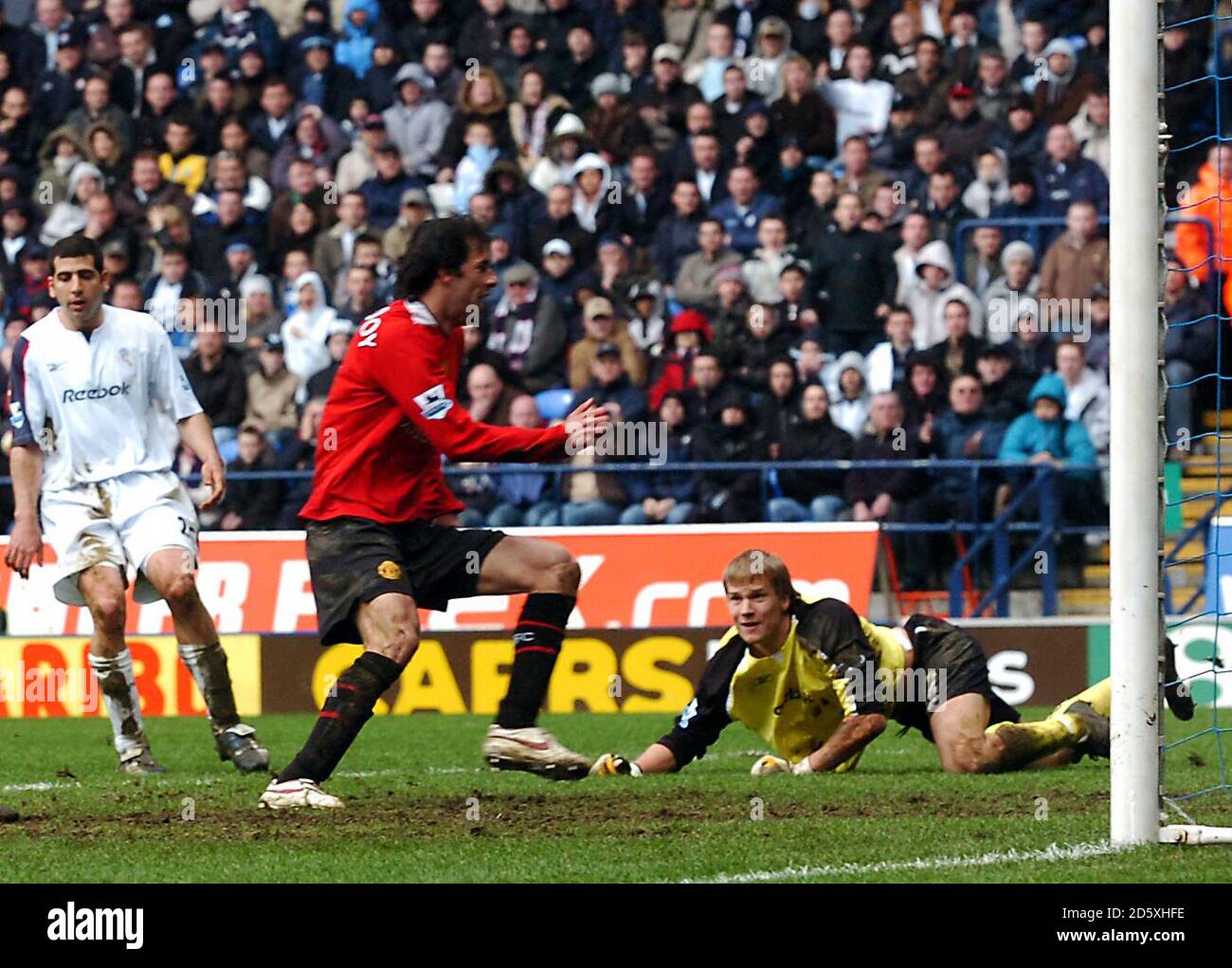 Bolton Wanderers' goalkeeper Jussi Jaaskelainen looks dejected as Manchester United's Ruud van Nistelrooy scores the winning goal Stock Photo