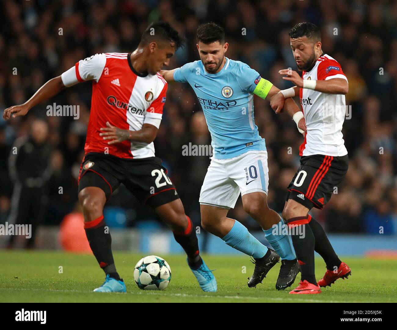 Manchester City's Sergio Aguero (left) battles for the ball with Feyenoord's Renato Tapia (left) and Tonny Vilhena Stock Photo