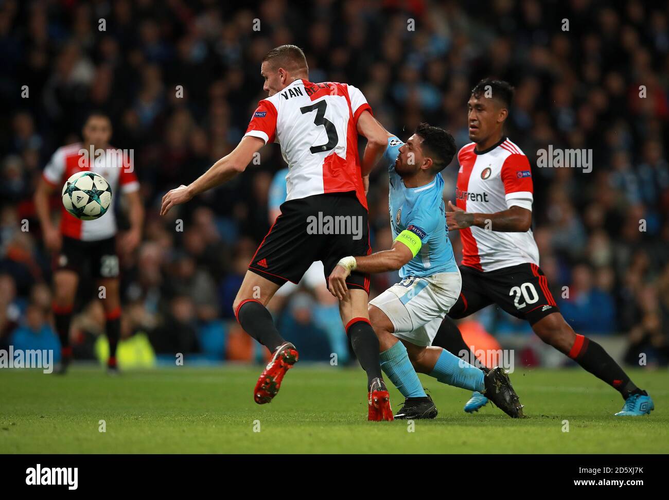 Manchester City's Sergio Aguero (left) battles for the ball with Feyenoord's Sven van Beek (left) and Renato Tapia Stock Photo