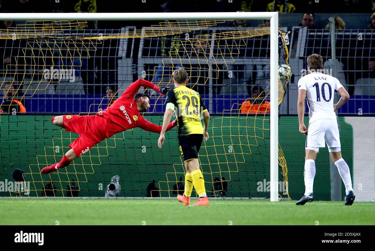 Borussia Dortmund's goalkeeper Roman Burki (left) dives as Tottenham Hotspur's Son Heung-Min (not in picture) scores his side's second goal of the game as Tottenham Hotspur's Harry Kane (right) looks on Stock Photo