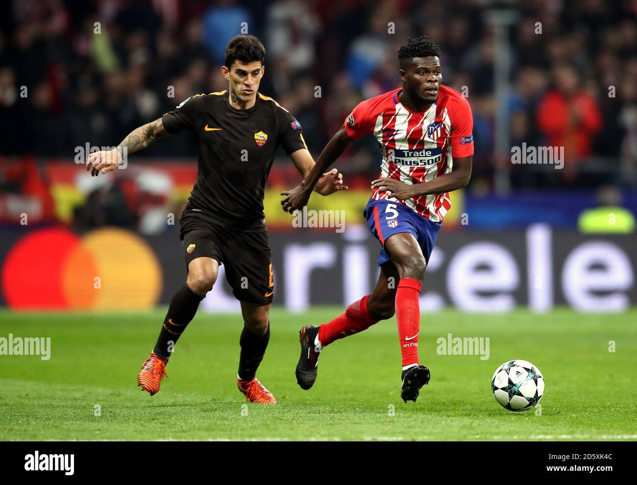 AS Roma's Diego Perotti (left) and Atletico Madrid's Thomas (right) battle for the ball  Stock Photo
