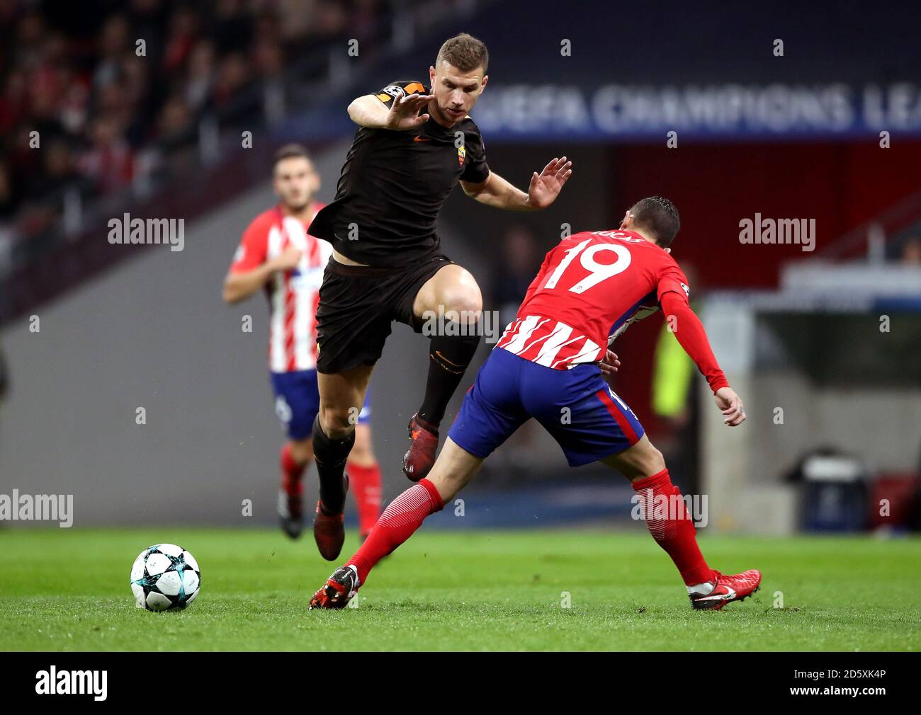 AS Roma's Edin Dzeko (left) and Atletico Madrid's Lucas Hernandez (right) battle for the ball Stock Photo