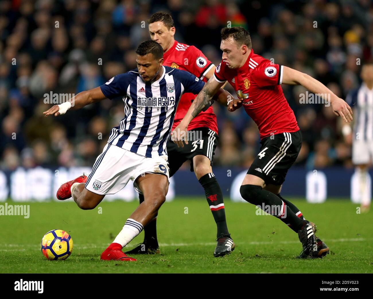 West Bromwich Albion's Salomon Rondon (left) battles for the ball against Manchester United's Nemanja Matic and Phil Jones (right) Stock Photo