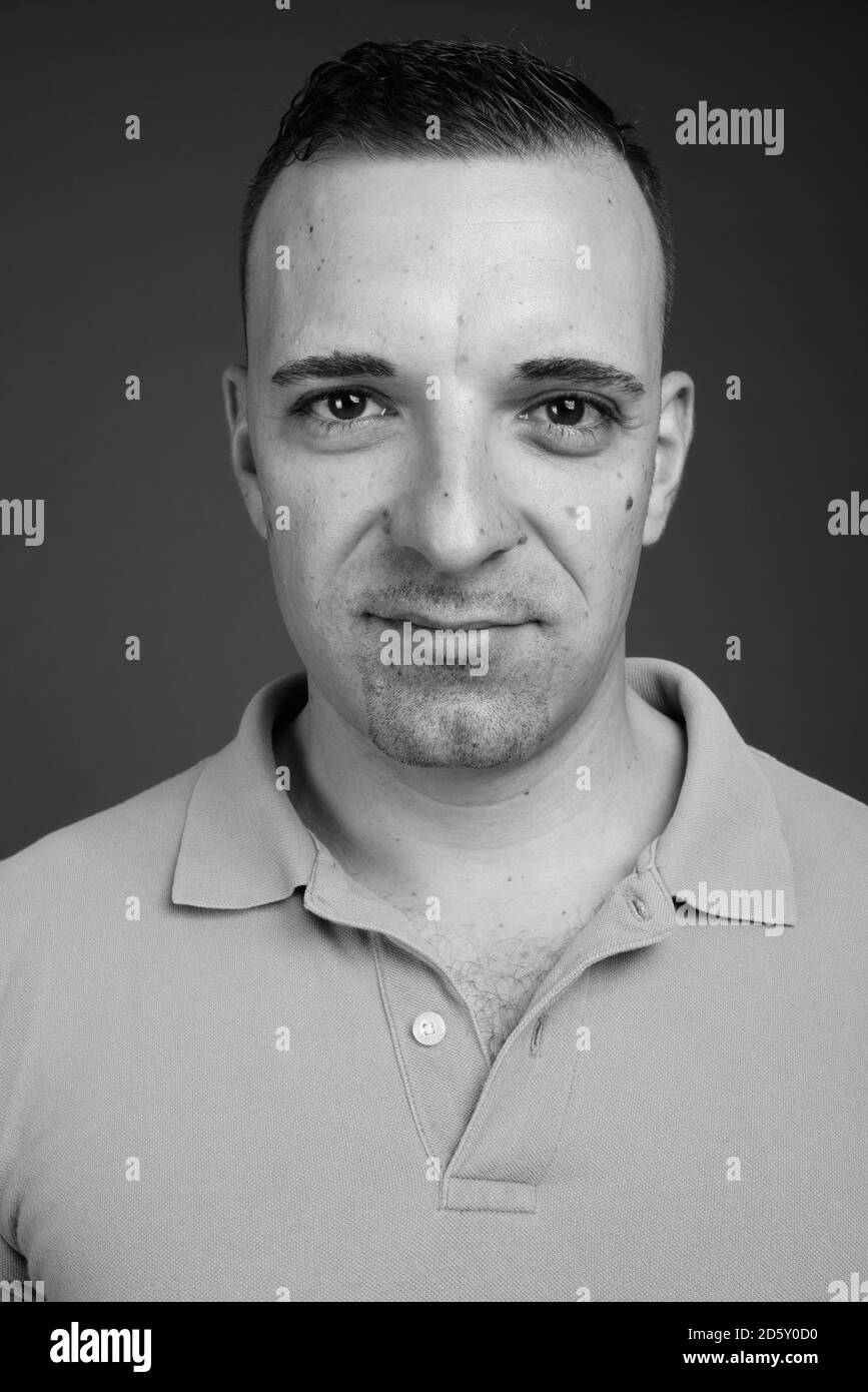 Portrait of handsome man against gray background Stock Photo - Alamy