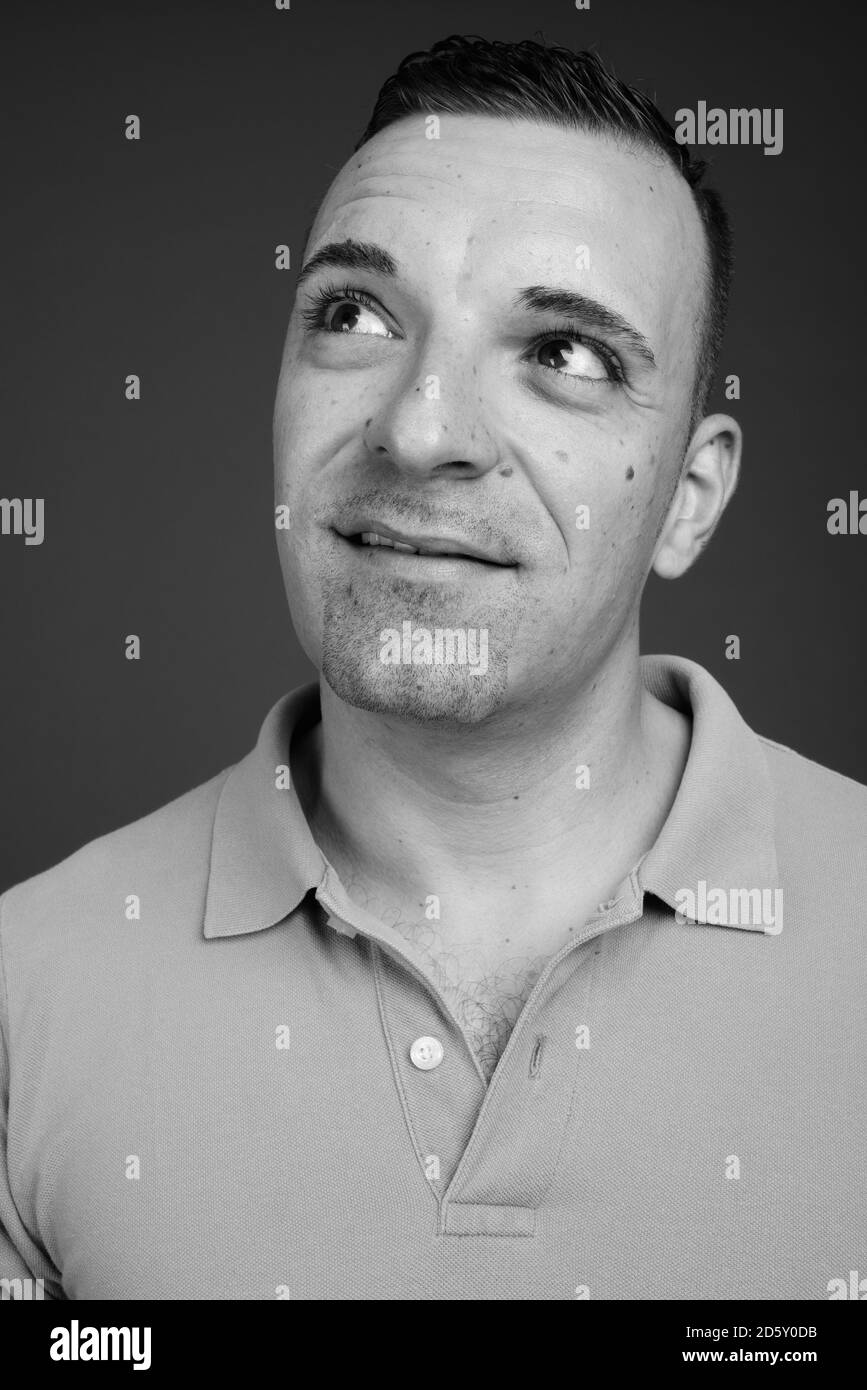 Portrait of handsome man against gray background Stock Photo - Alamy