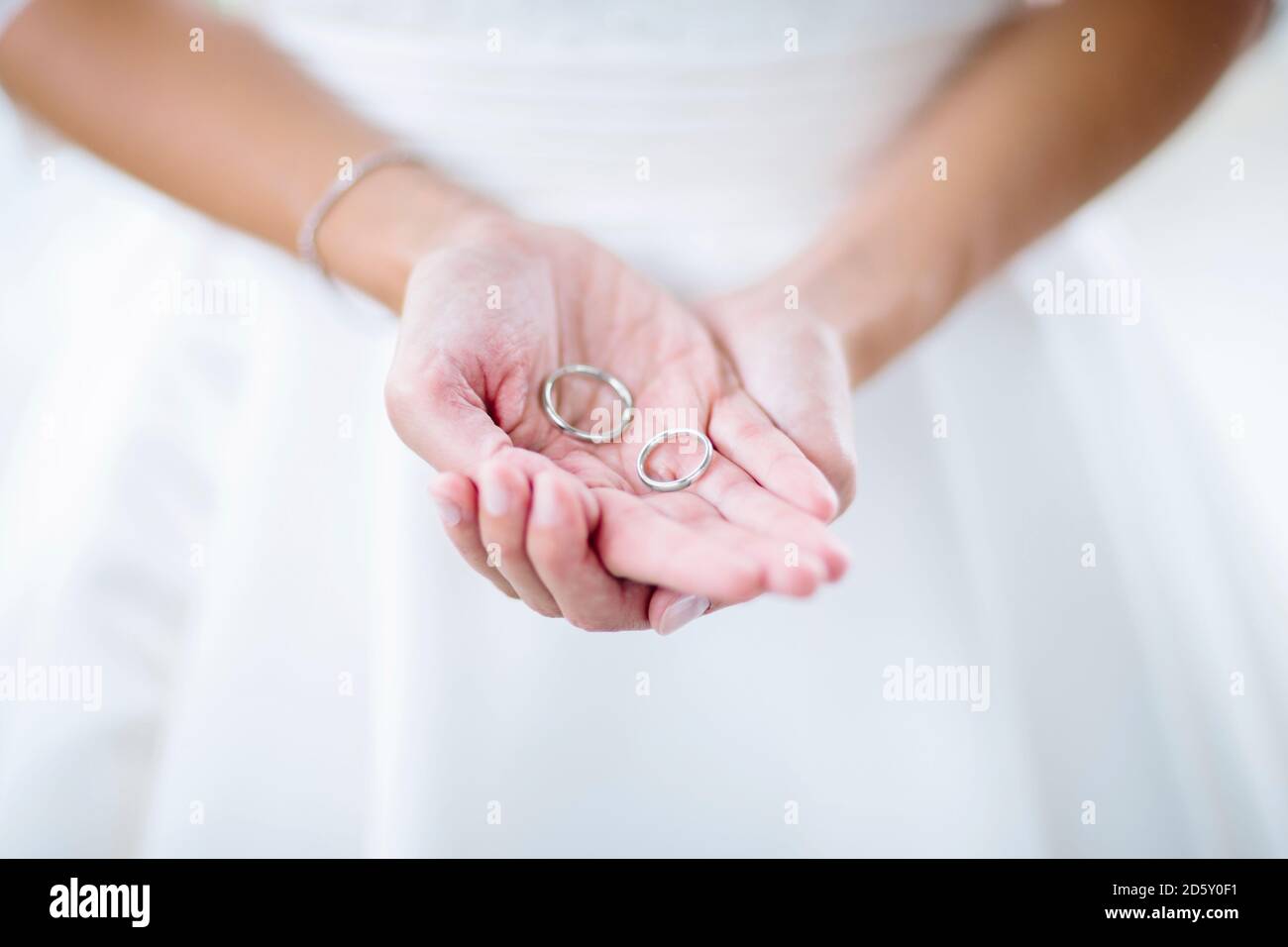 Brides maid holding wedding rings Stock Photo