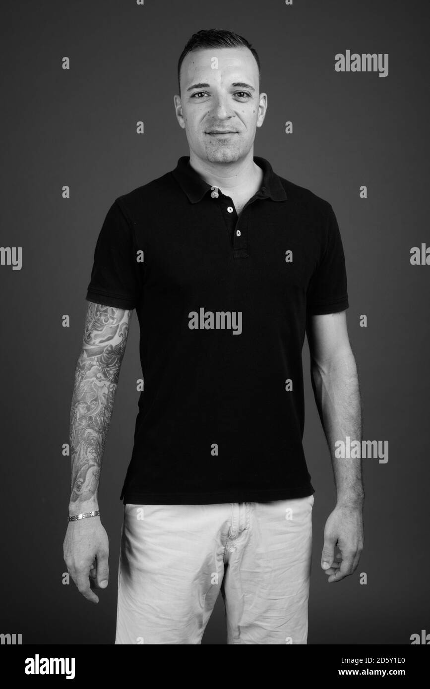 Man wearing black shirt against gray background Stock Photo - Alamy