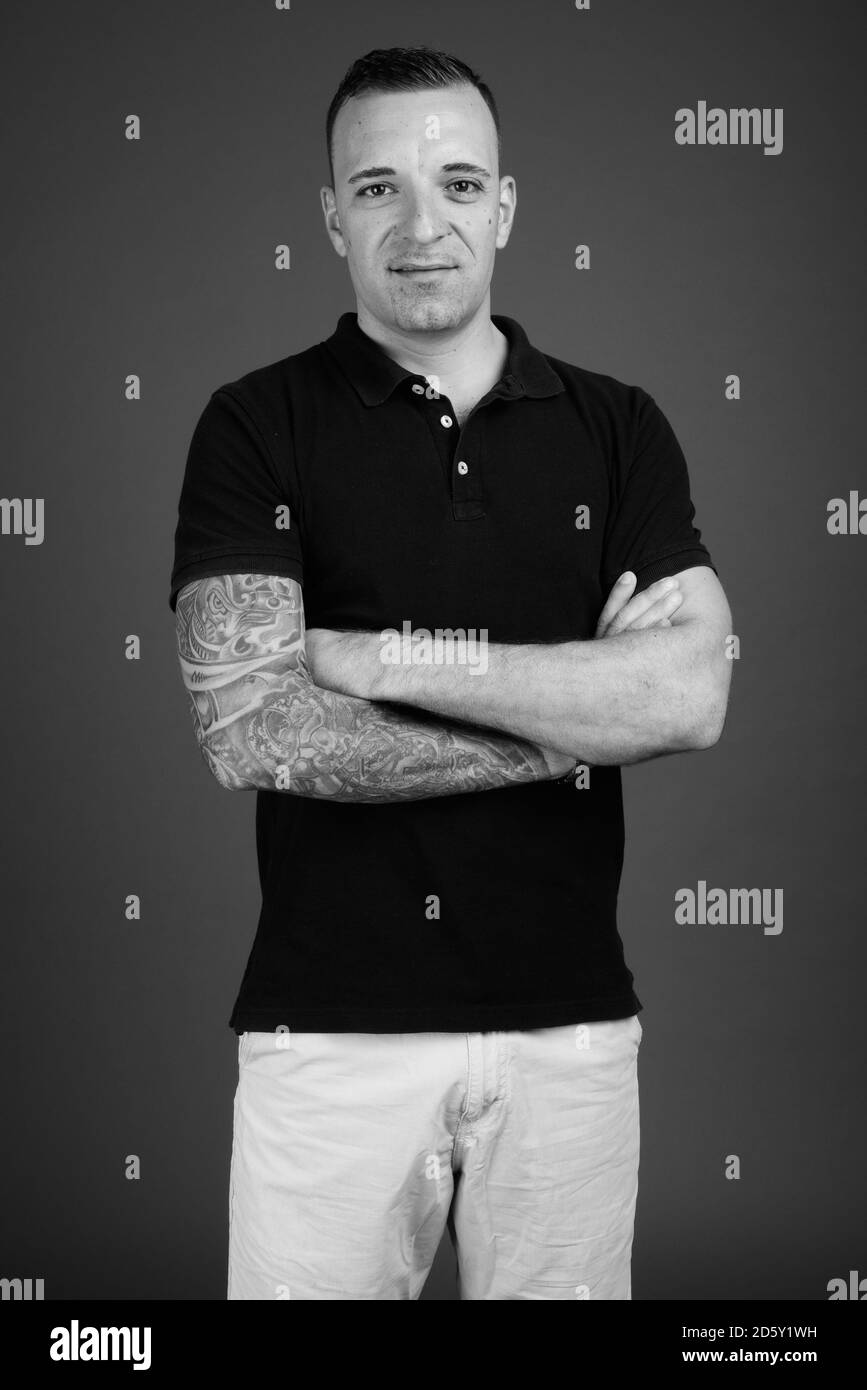 Man wearing black shirt against gray background Stock Photo - Alamy