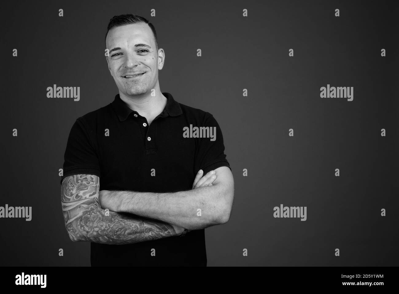 Man wearing black shirt against gray background Stock Photo - Alamy