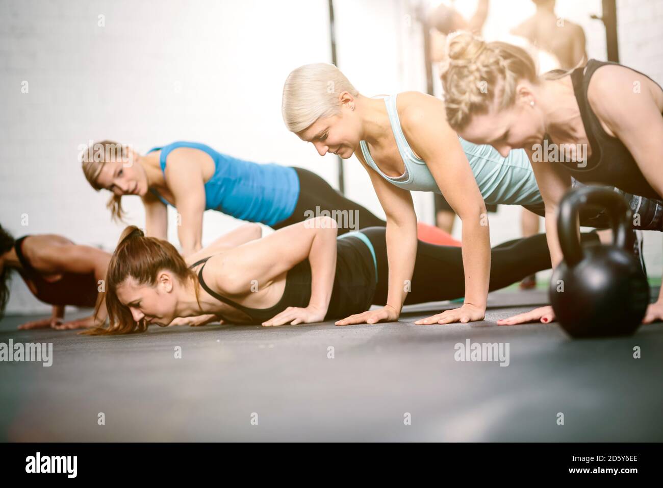 People in gym doing push ups Stock Photo
