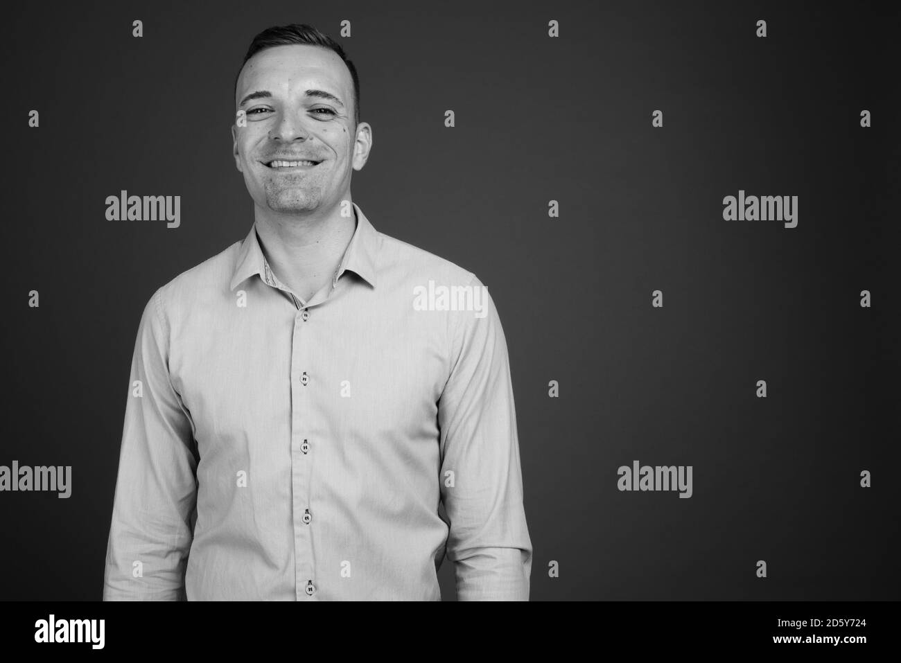 Businessman against gray background Stock Photo - Alamy