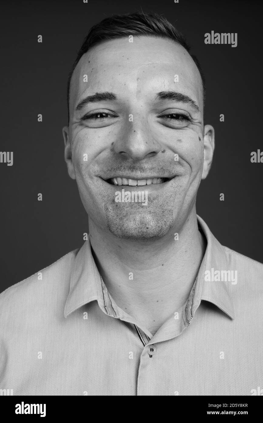 Businessman against gray background Stock Photo - Alamy