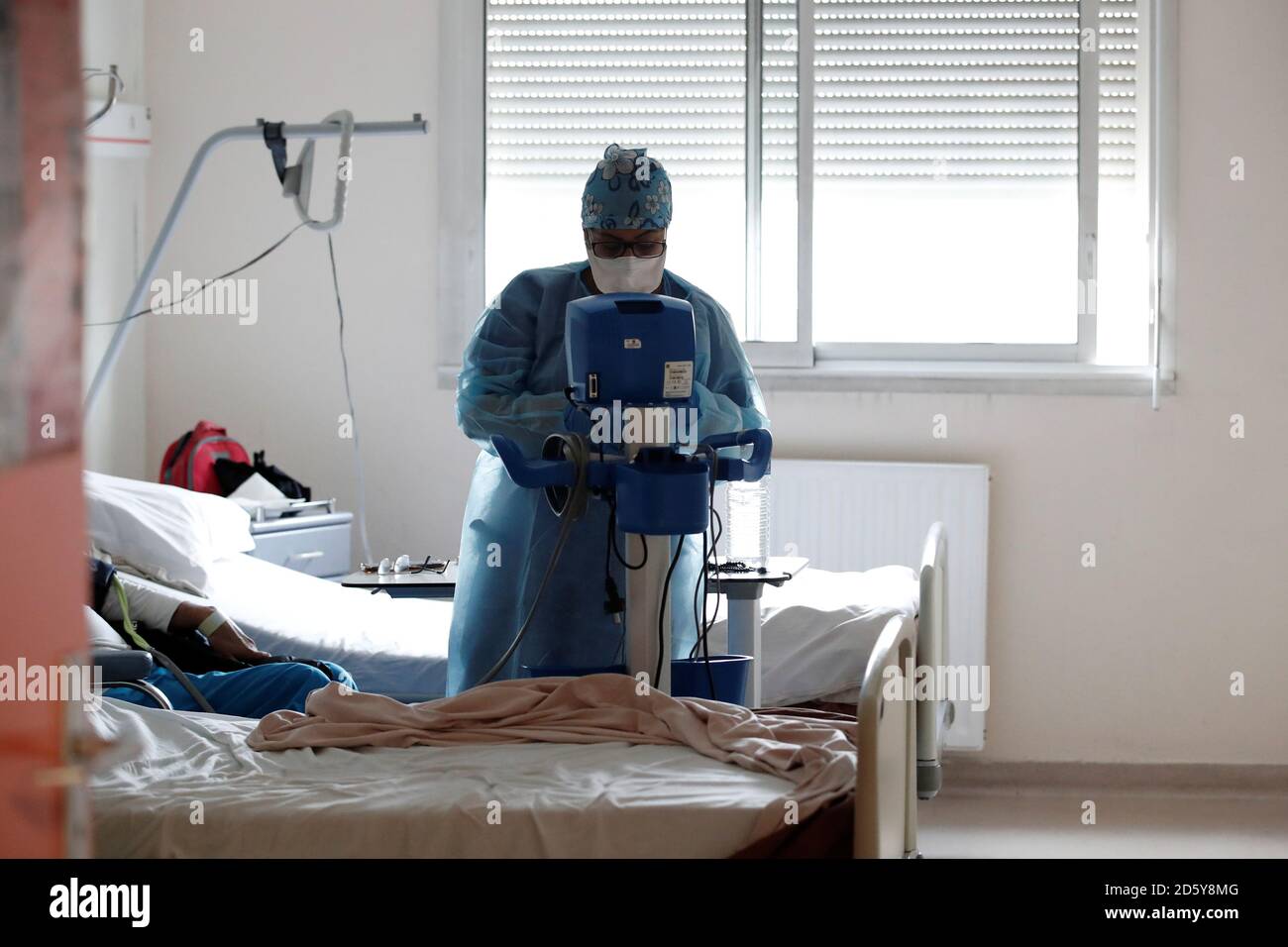 A medical worker, wearing a protective mask and a protective suit, works in  a medicine unit at the Clinique de l'Estree - ELSAN private hospital in  Stains where patients suffering from the