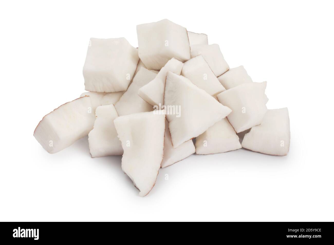 Studio shot of small pieces of coconut cut out against a white background - John Gollop Stock Photo