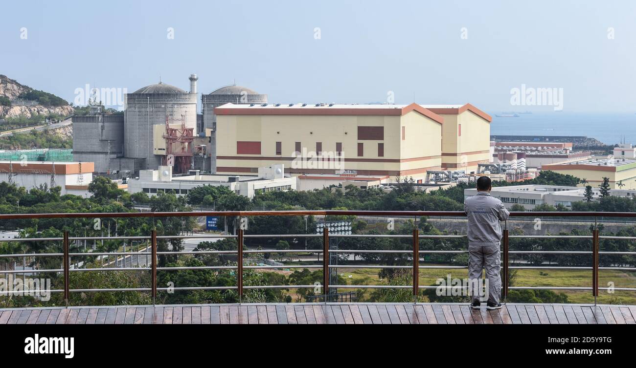 (201014) -- SHENZHEN, Oct. 14, 2020 (Xinhua) -- Qiao Sukai overlooks the Dayawan Nuclear Power Plant in Shenzhen, south China's Guangdong Province, Nov. 20, 2019. Every 18 months, the Dayawan Nuclear Power Plant has to undergo a fuel assemblies replacement, which is one of the most important moments for the nuclear power plant. Dozens of engineers are divided into four shifts and operate the equipment day and night when the reactor is shut down. Their leader, Qiao Sukai, has been dealing with nuclear fuel since July 1993 when the nuclear fuel assembly of Dayawan Nuclear Power Plant arrived. Stock Photo