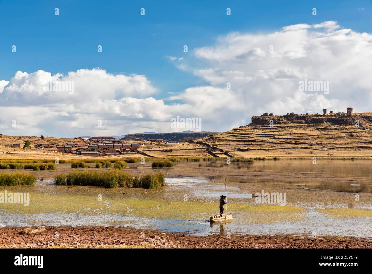 Peru, Andes, cemetery of Sillustani at Lake Umayo and fisherman on boat made of giant bulrush Stock Photo