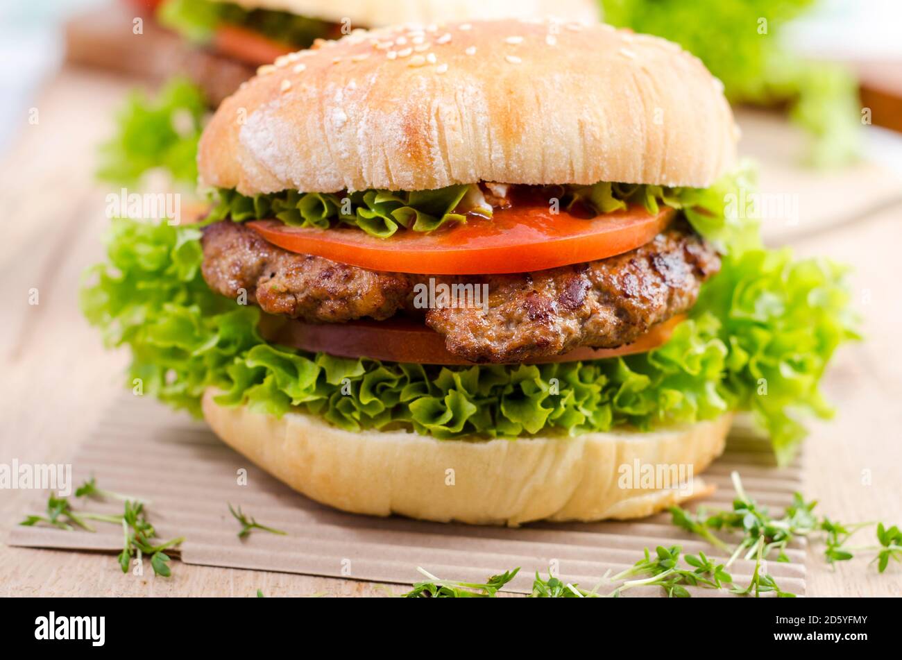 Homemade hamburger with minced beef and lettuce on sesame roll Stock Photo