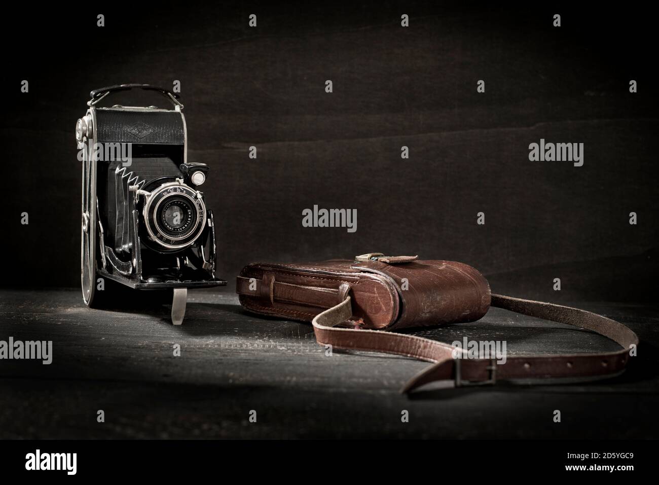 Old camera and leather bag Stock Photo