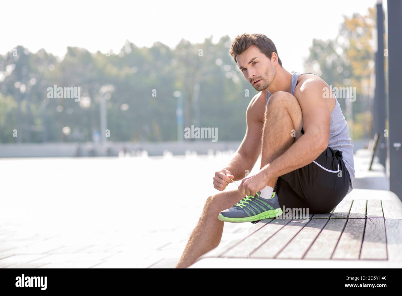 Jogger doing up his shoelace Stock Photo