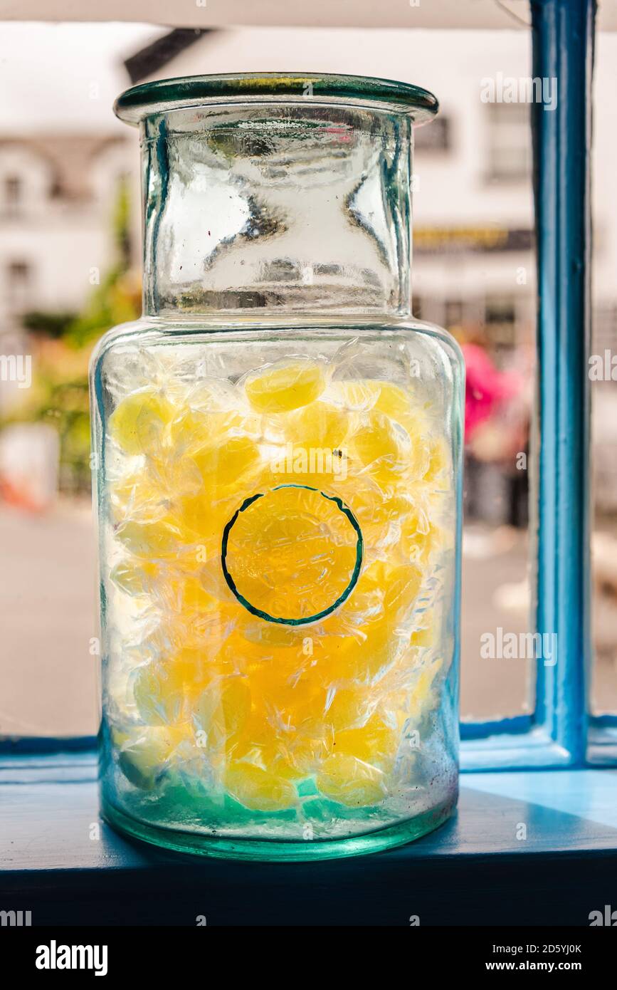 Old fashioned glass sweet jar in the window of a sweet shop Stock Photo