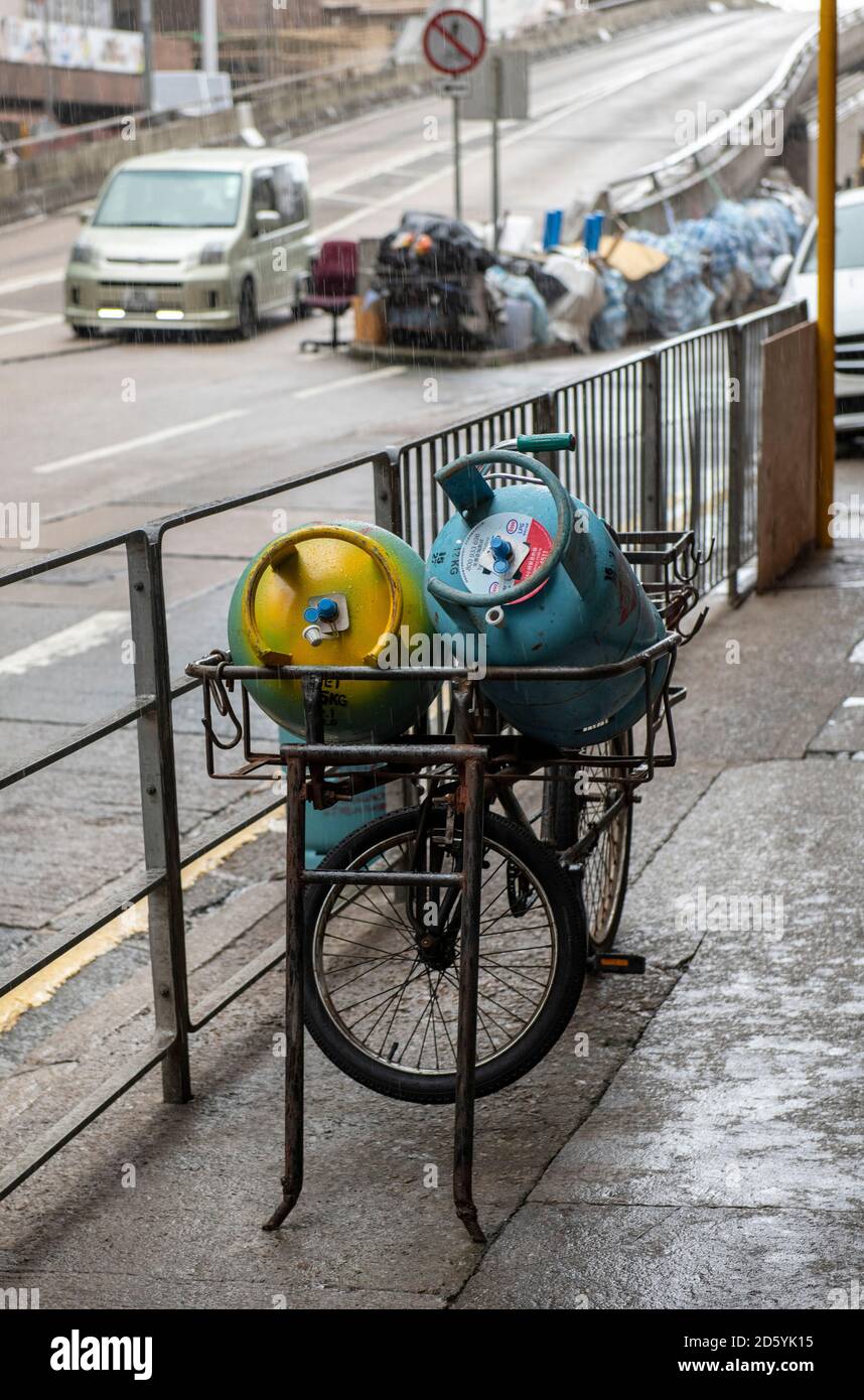 Hong Kong, Hong Kong, China. 1st Aug, 2020. Hong Kong, China:01 Aug, 2020. Gas bottles sit on the front of a delivery cycle in a rainstorm.Alamy Stock Image/Jayne Russell. Credit: Jayne Russell/ZUMA Wire/Alamy Live News Stock Photo