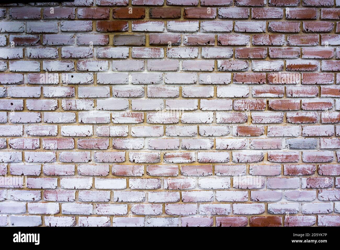Background of a red brick wall painted white. Brick tiles texture Stock