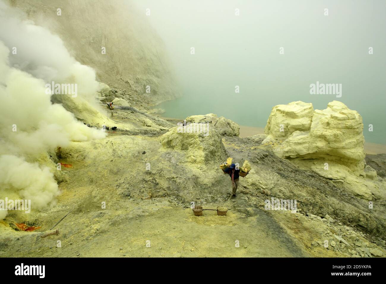 Sulphur miners working in the crater at kawah ijen hi-res stock ...