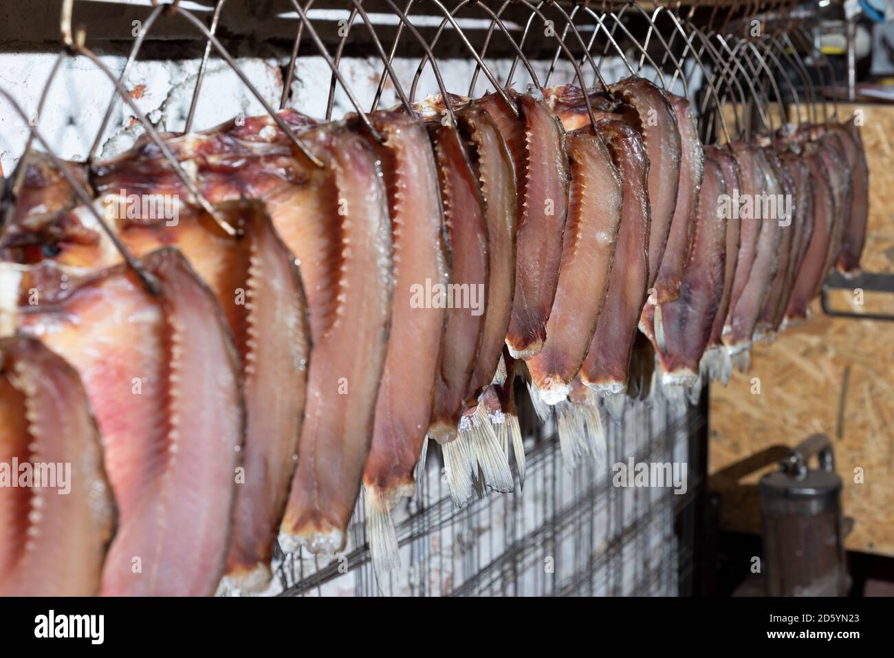smoked fish carcasses are raised in a row after smoking on the air Cold