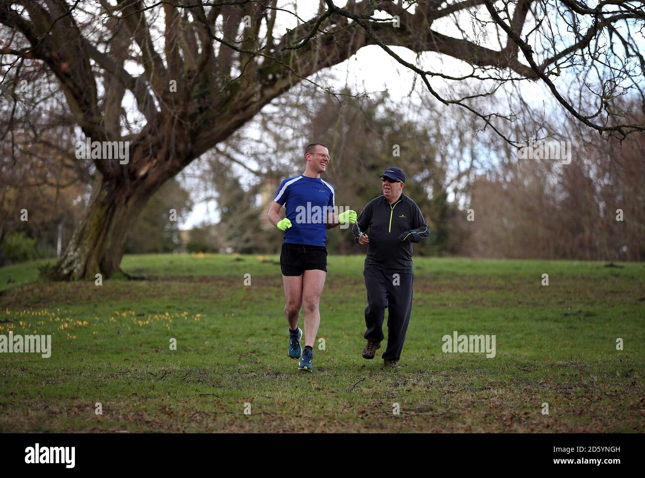 Andrew Russell (left) guides Derek Gardner (a blind jogger) as they ...
